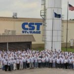 CST staff photo in front of CST Storage building