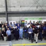 group photo in front of gray wall