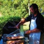 Man in apron grilling