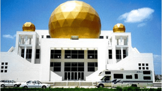 White building with large golden balls on roof