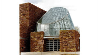 Stone building with glass structure on top