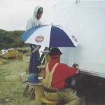 workers building dome under umbrella
