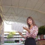 woman viewing model of covered trussed standing under a truss ceiling
