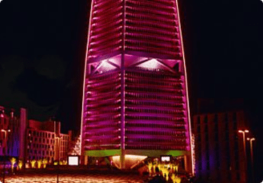 large building lit up pink at night