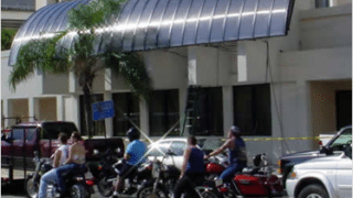 Bikers in front of building