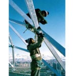 2 men building trusses outside